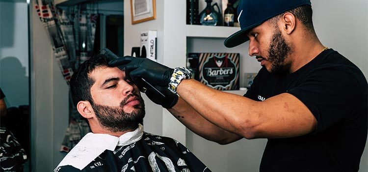 In Mumbai barber gives first customer haircut with golden scissors after salons reopen In Mumbai barber gives first customer haircut with golden scissors after salons reopen